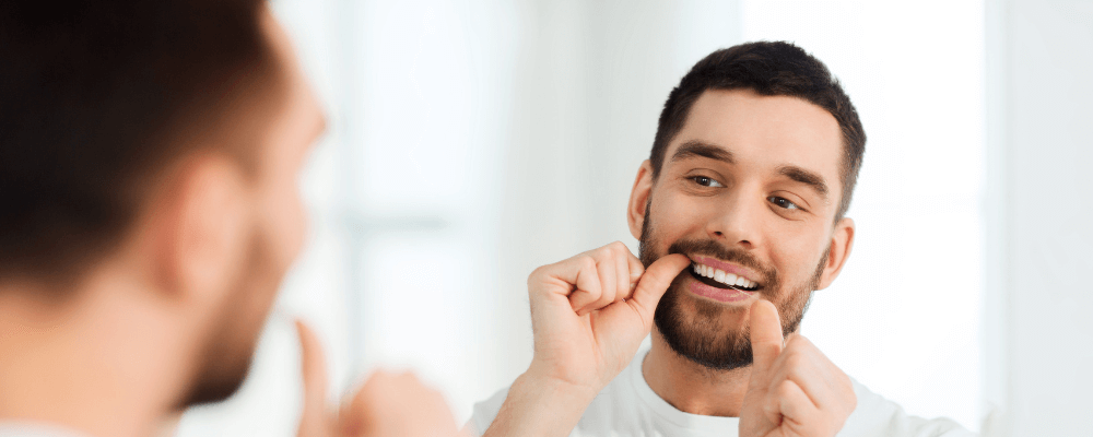 Man flossing for better oral health